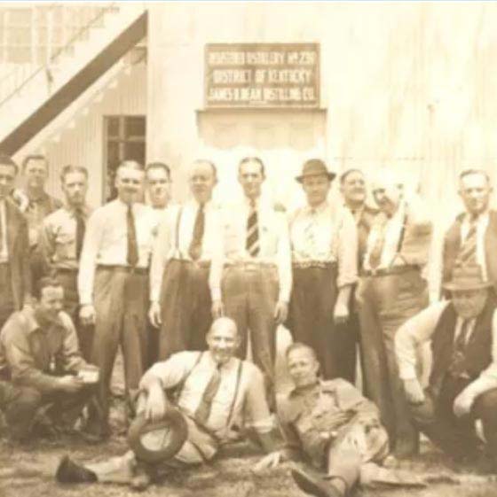 Jim Beam’s staff posing in front of the James B.Beam Distilling Co building