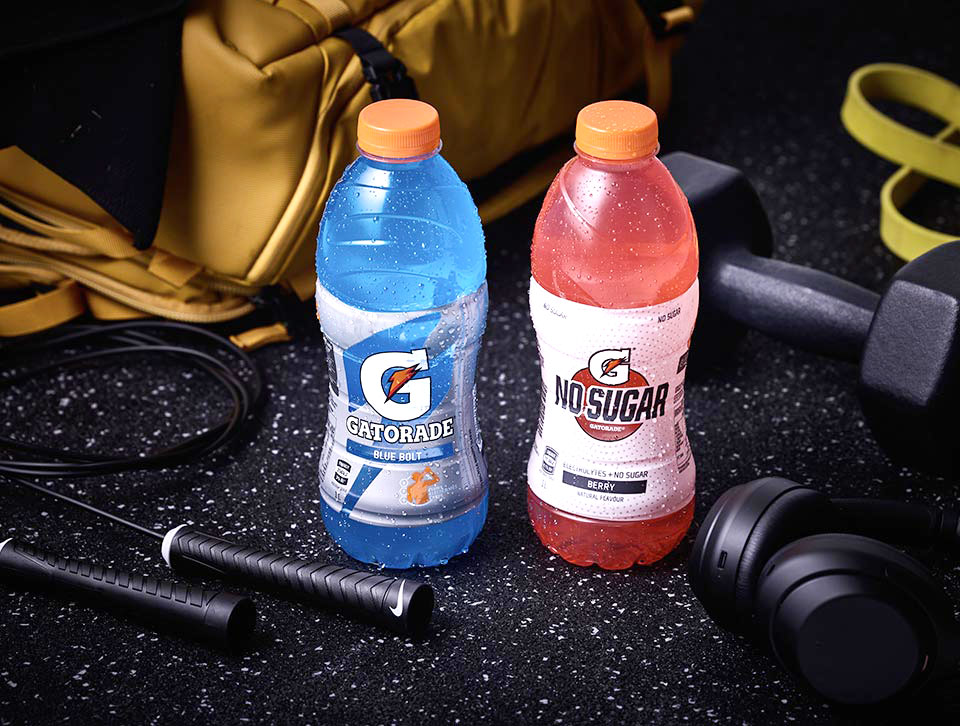 Gatorade Blue Bolt and No Sugar Berry against a gym background