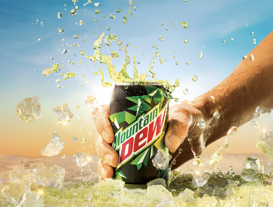 Hand holding a Mountain Dew can on a table with ice