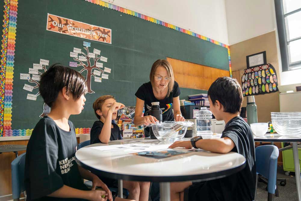 A teacher instructing students in a classroom.