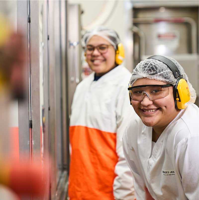 Two workers in the factory posing for the camera