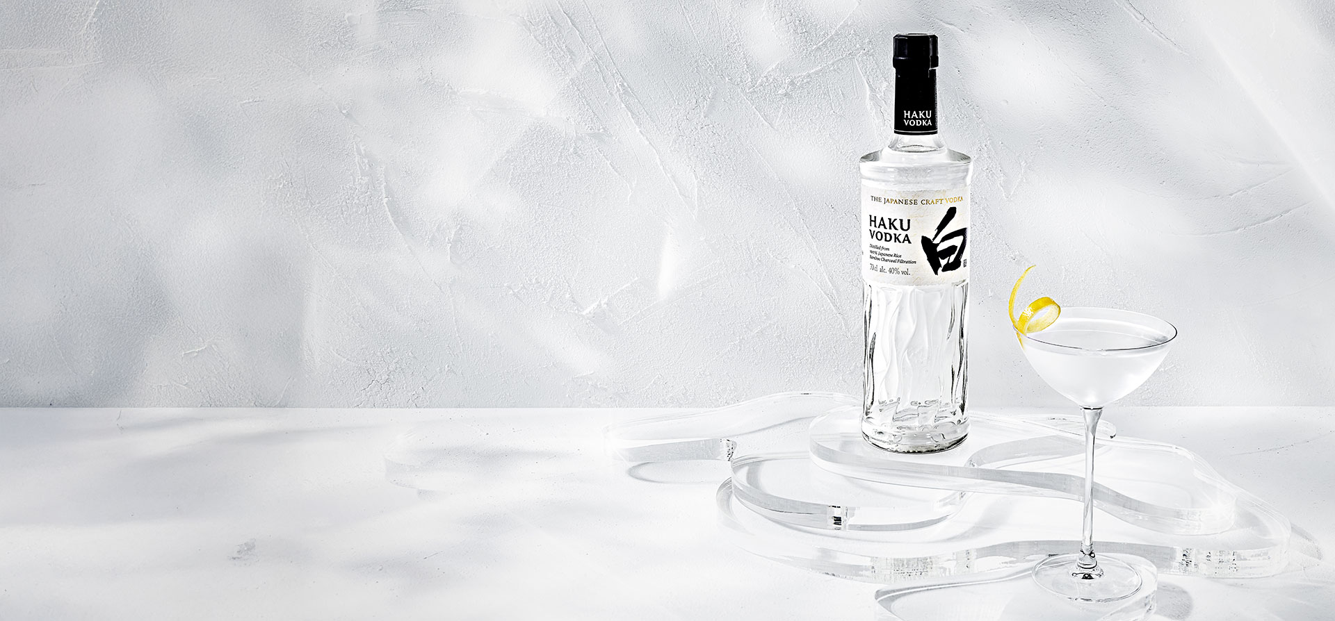 A bottle of Haku vodka and a cocktail against a white background