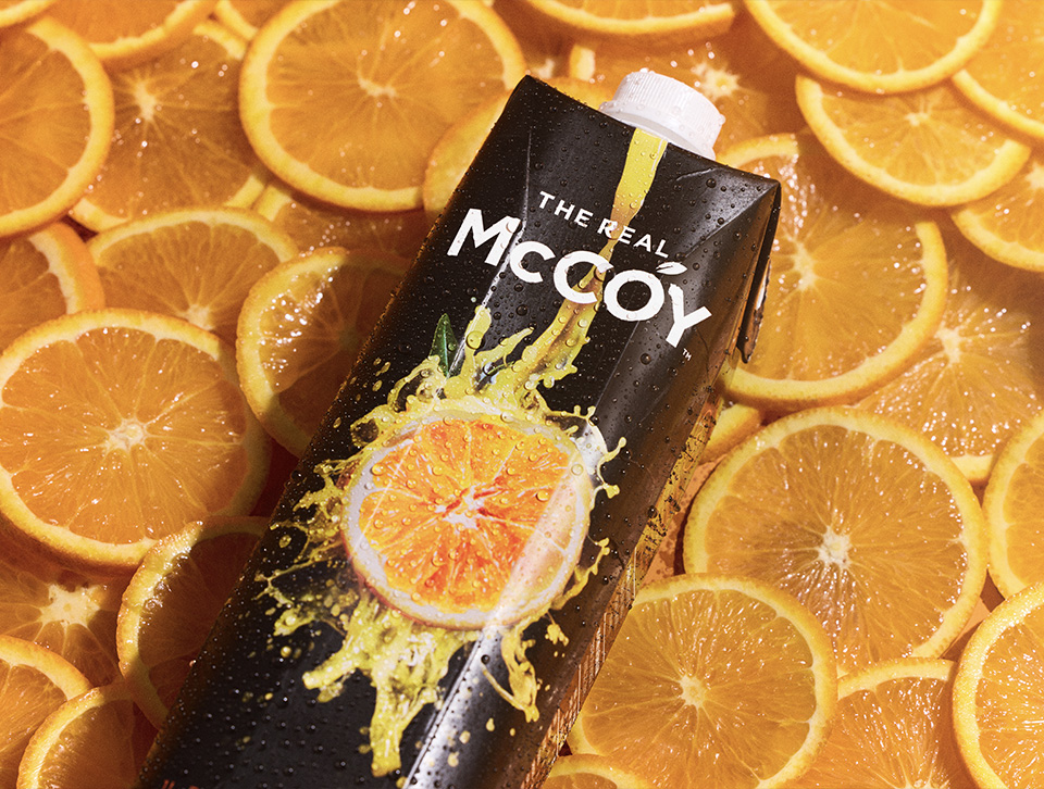 The Real McCoy carton on top of orange slices