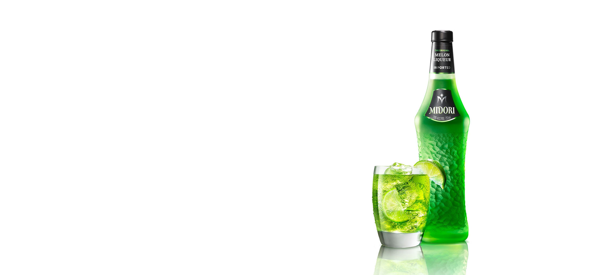 A bottle and glass of Midori liqueur