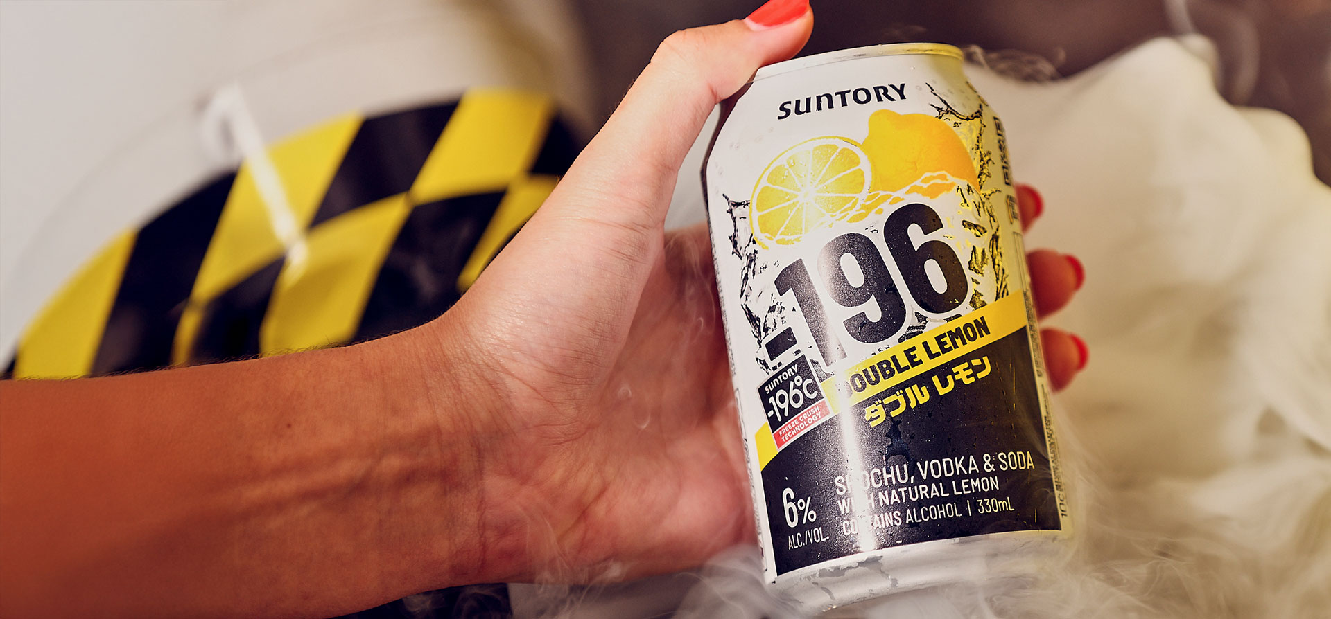 Hand holding a can of Minus 196 double lemon flavour