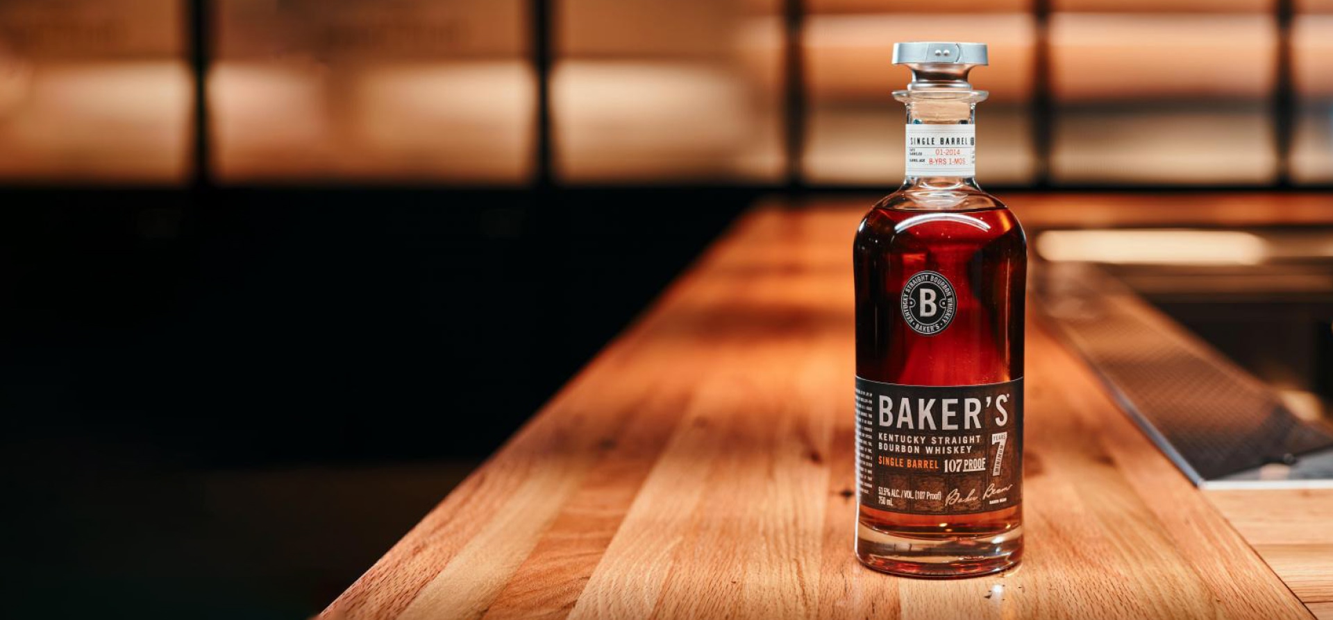 A bottle of Baker's on a wooden bench