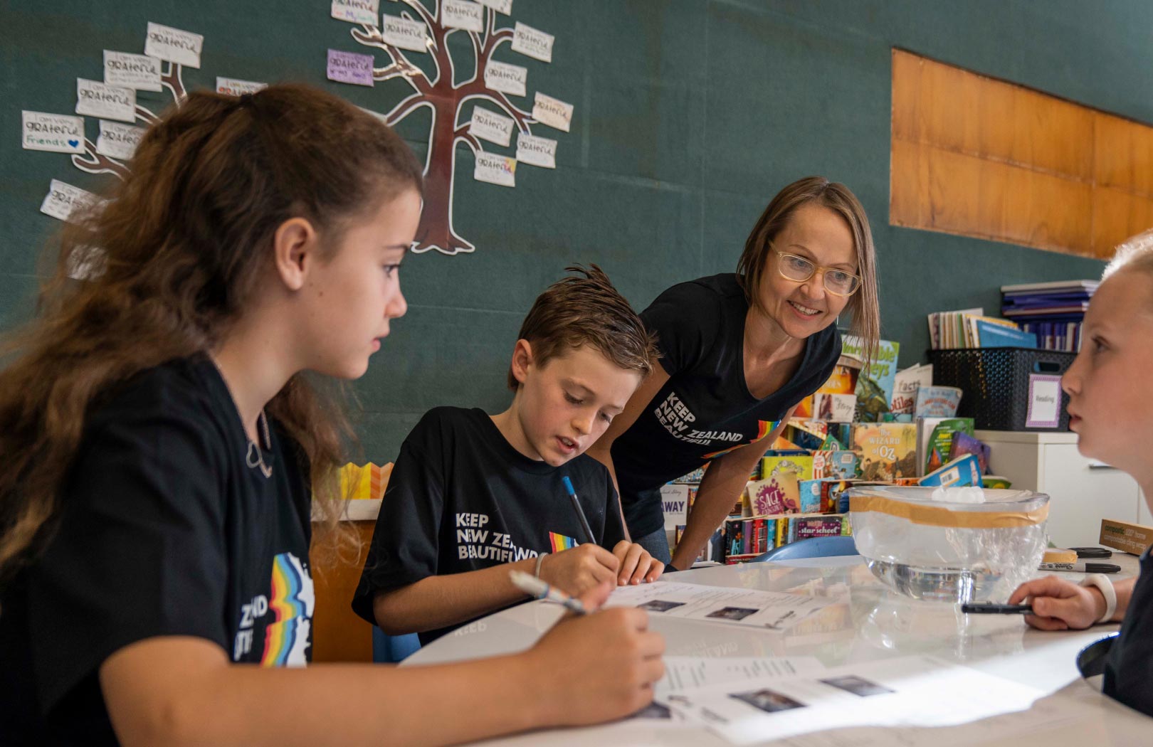 A teacher communicating with students in a classroom.