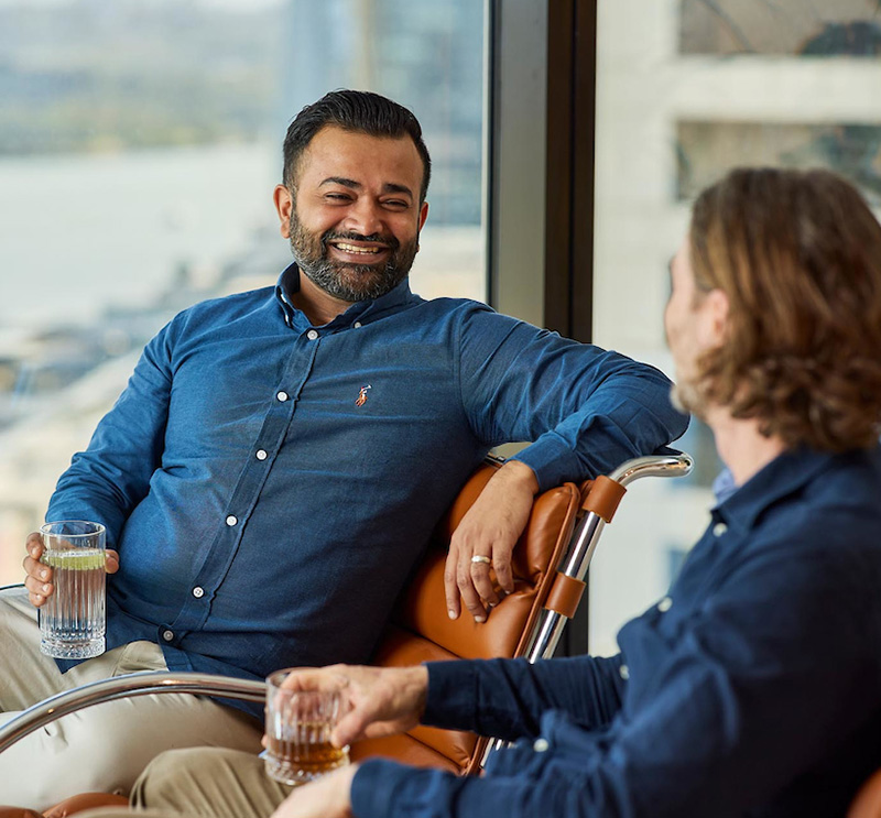 Two workers engaging in conversation in an office