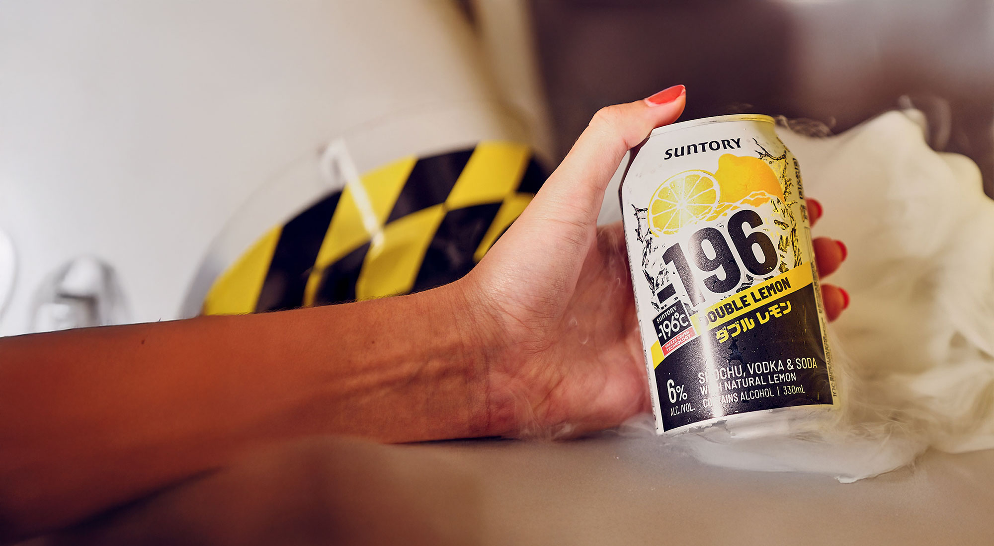 Hand holding a can of Minus 196 Double Lemon